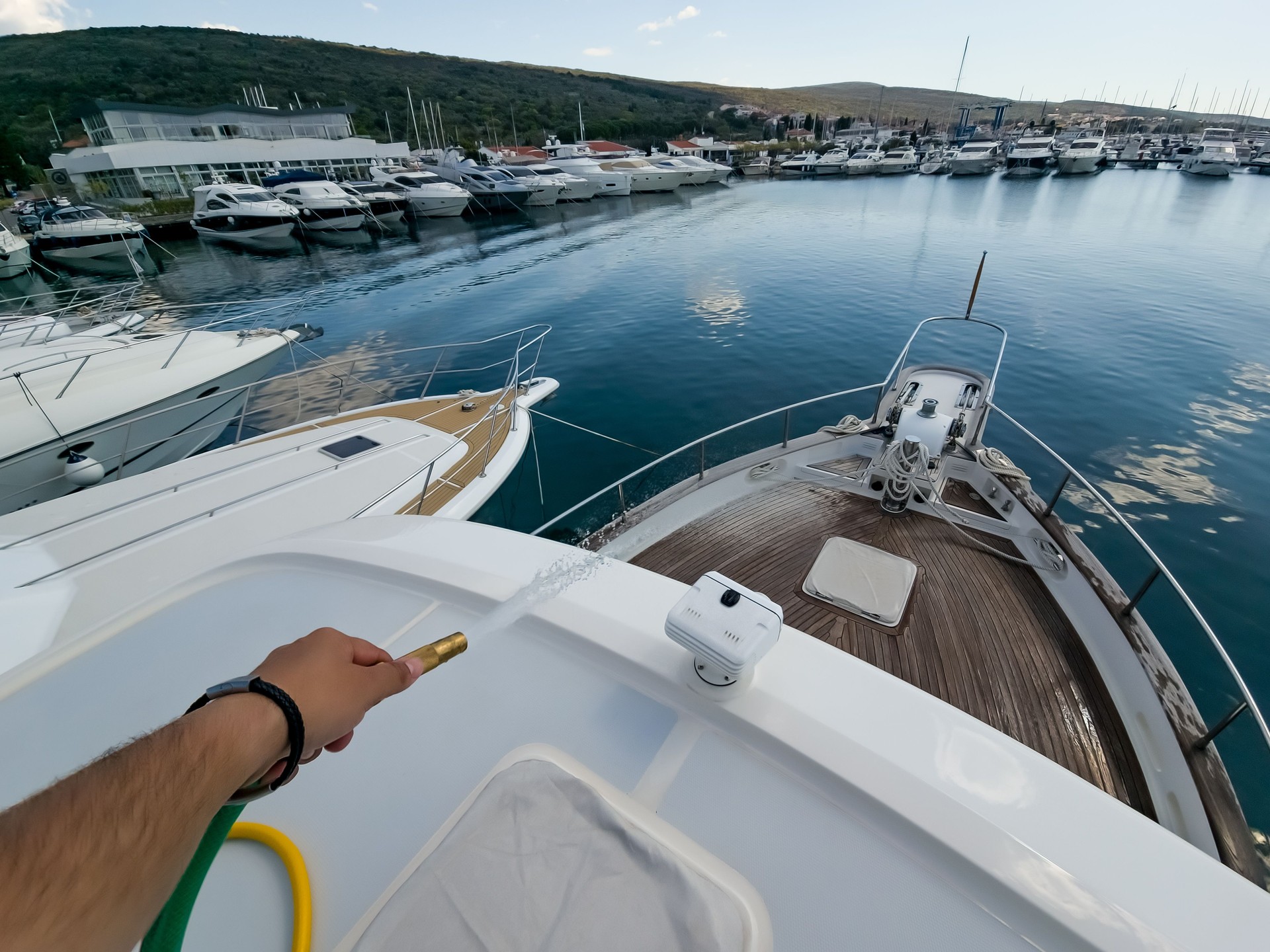 Latino Worker Cleaning Luxury Yacht Deck At Mediterranean Marina